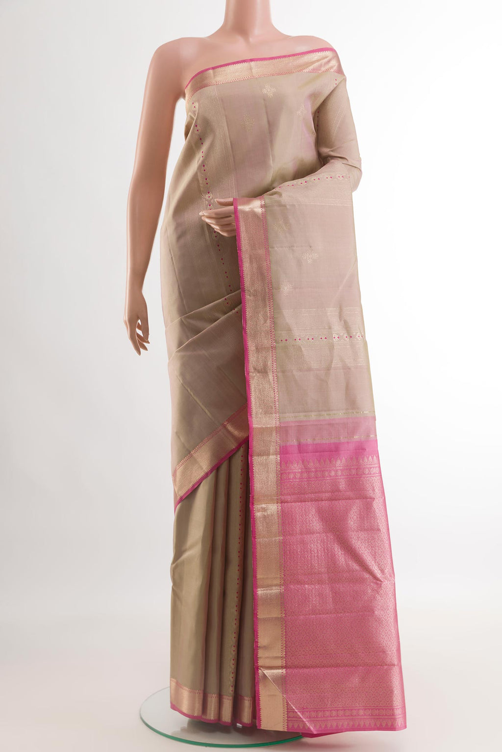 Rose Gold Kanjivaram Silk Saree with Zari Butta on the body and Zari Border.  displayed on a mannequin