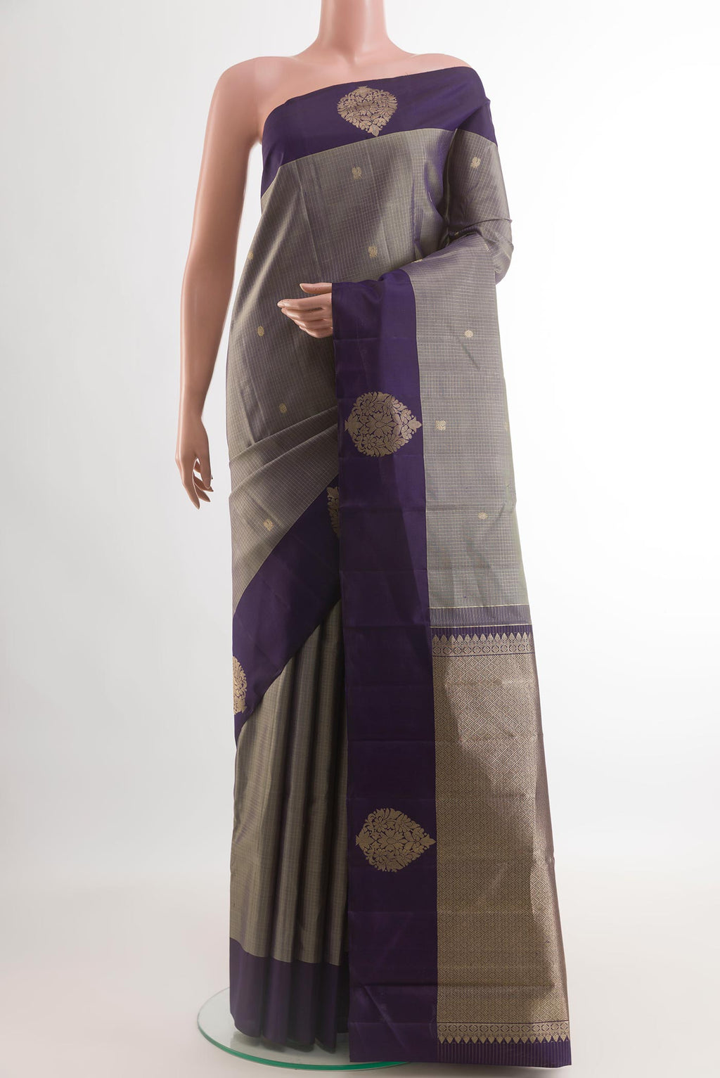 Grey Kanjivaram Silk Saree with Zari Butta on the body and Zari Border.  displayed on a mannequin