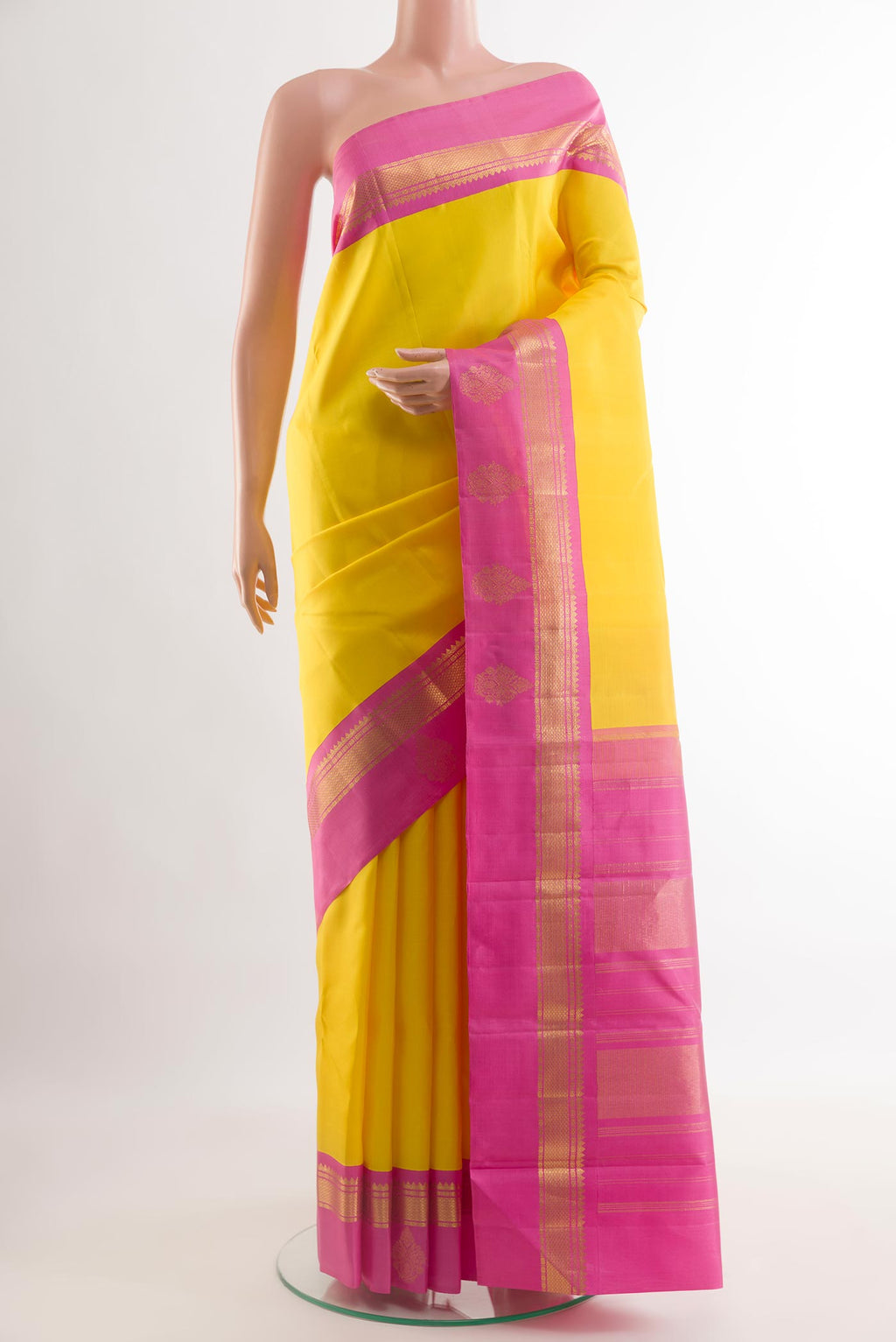 Yellow Kanjivaram Silk Saree with Plain Body and Zari Border.  displayed on a mannequin