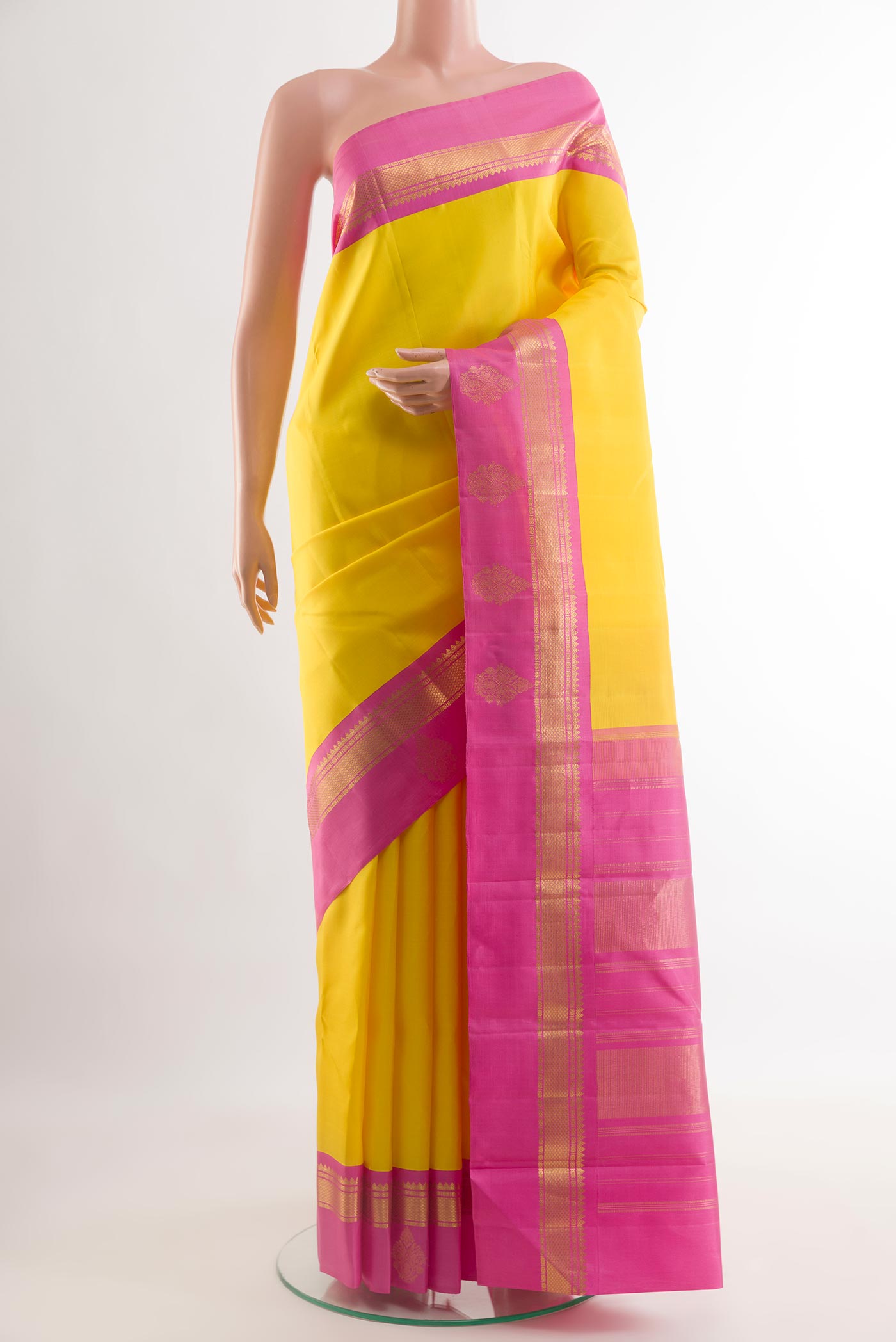 Yellow Kanjivaram Silk Saree with Plain Body and Zari Border.  displayed on a mannequin
