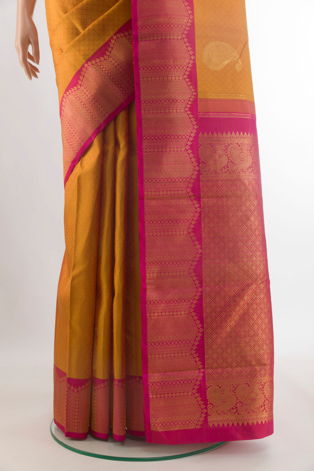 Pleats and pallu of Pure Silk Mustard Kanchipuram Saree with Jacquard With Zari Butta on the body and Zari Border. 