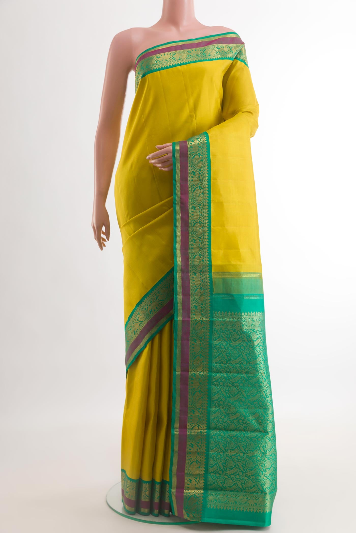 Yellow Kanjivaram Silk Saree with Zari Butta on the body and Zari Border.  displayed on a mannequin