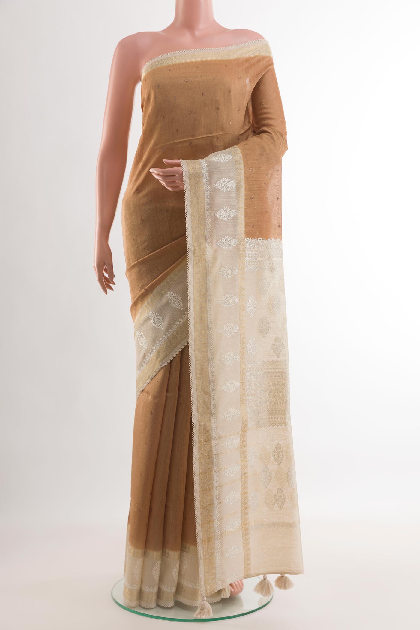 Brown Tussar Silk Saree with Embroidery on the body and Zari Border.  displayed on a mannequin