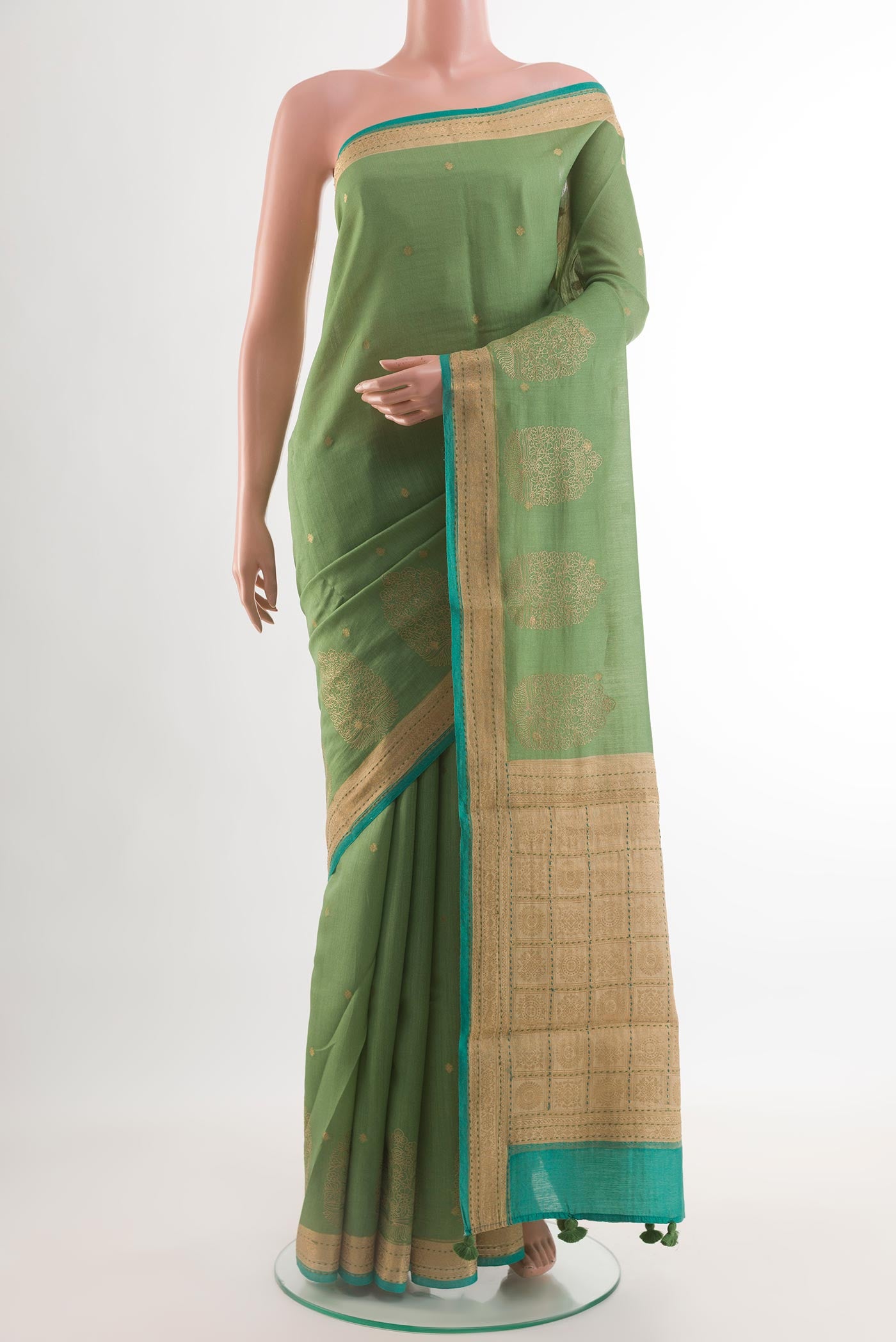 Green Tussar Silk Saree with Zari Butta on the body and Zari Border.  displayed on a mannequin
