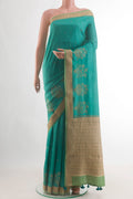 Blue Tussar Saree with Zari Butta on the body and Zari Border.  displayed on a mannequin