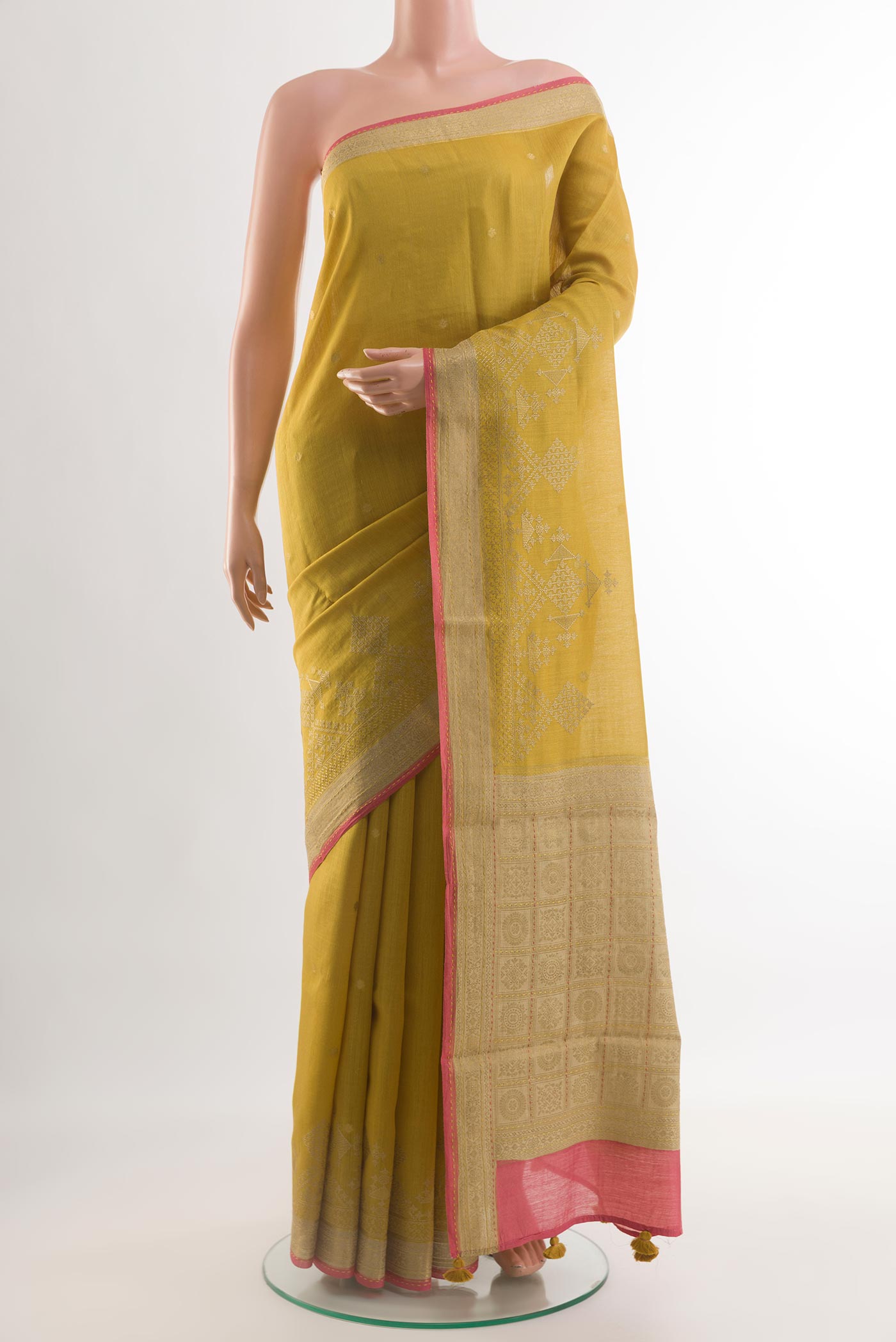Yellow Tussar Silk Saree with Embroidery on the body and Zari Border.  displayed on a mannequin