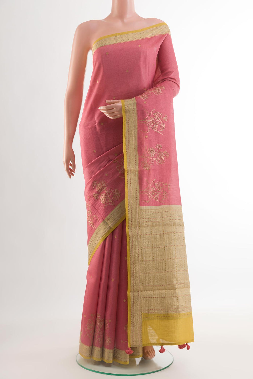 Coral Tussar Silk Saree with Embroidery on the body and Zari Border.  displayed on a mannequin