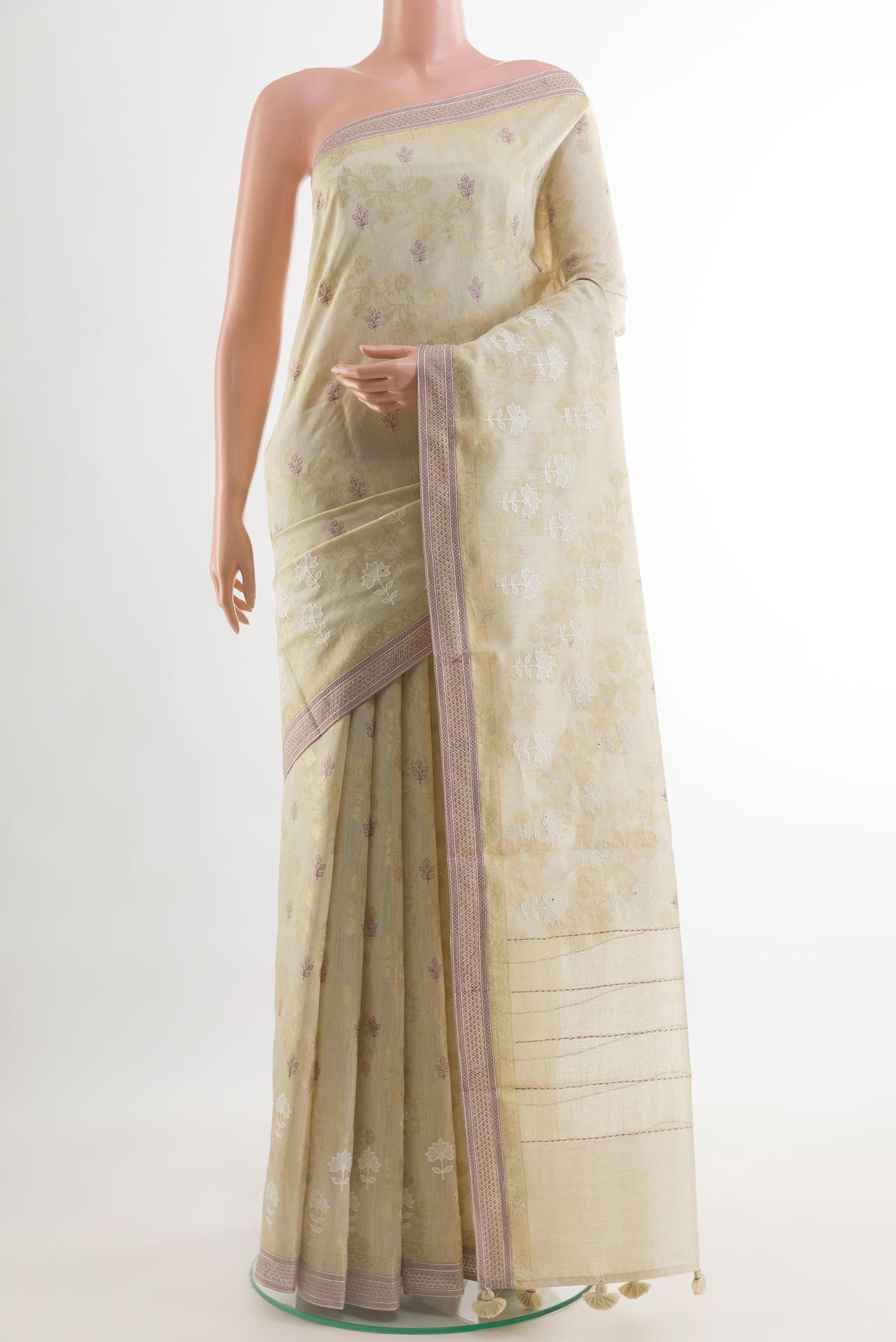 Cream Tussar Silk Saree with Embroidery on the body and Zari Border.  displayed on a mannequin
