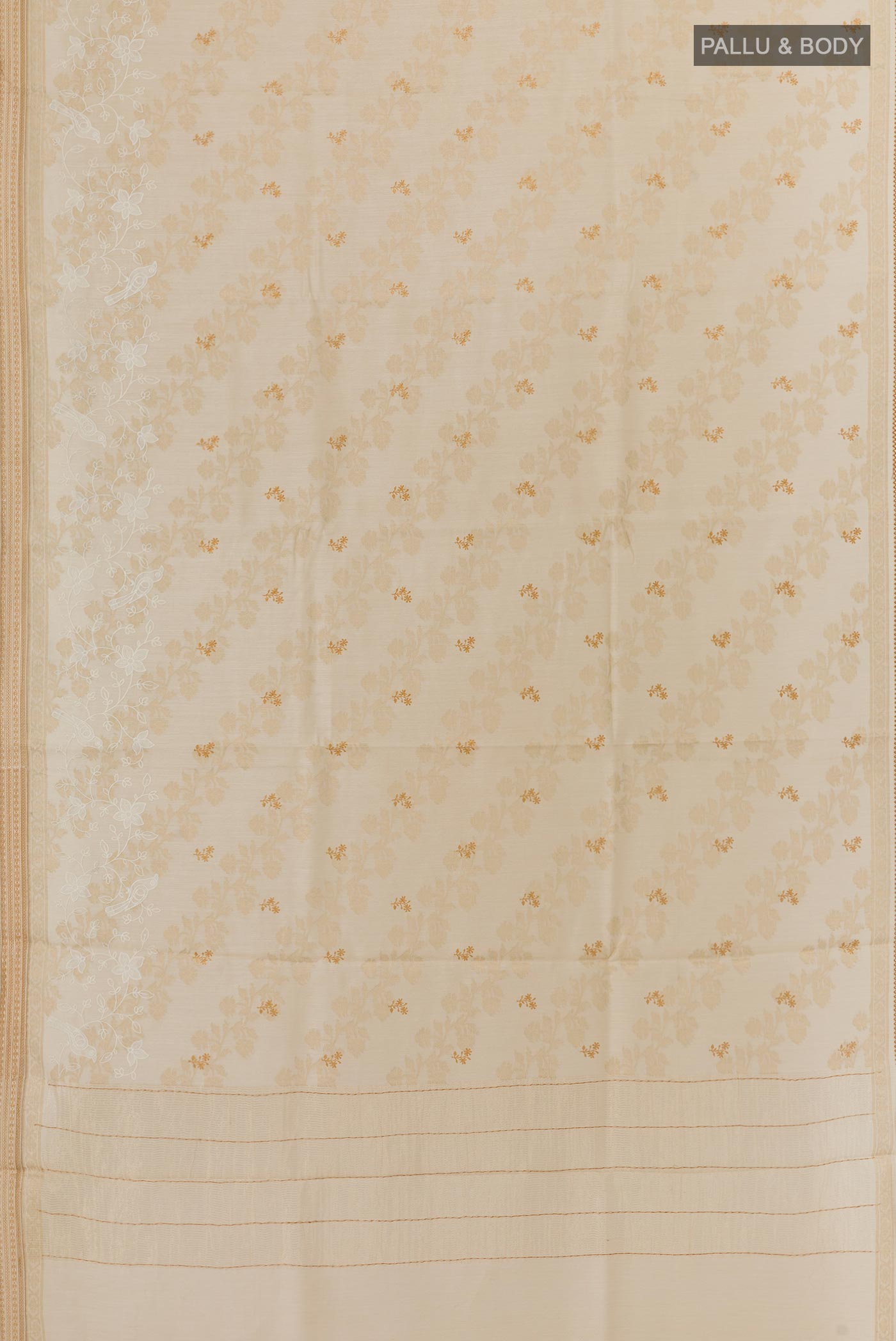 Flat view of Cream Tussar Silk Saree with Embroidery on the body and Zari Border. 