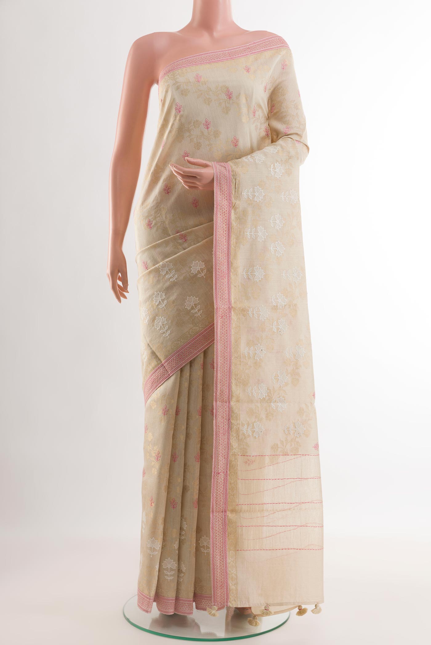 Beige Tussar Saree with Embroidery on the body and Zari Border.  displayed on a mannequin