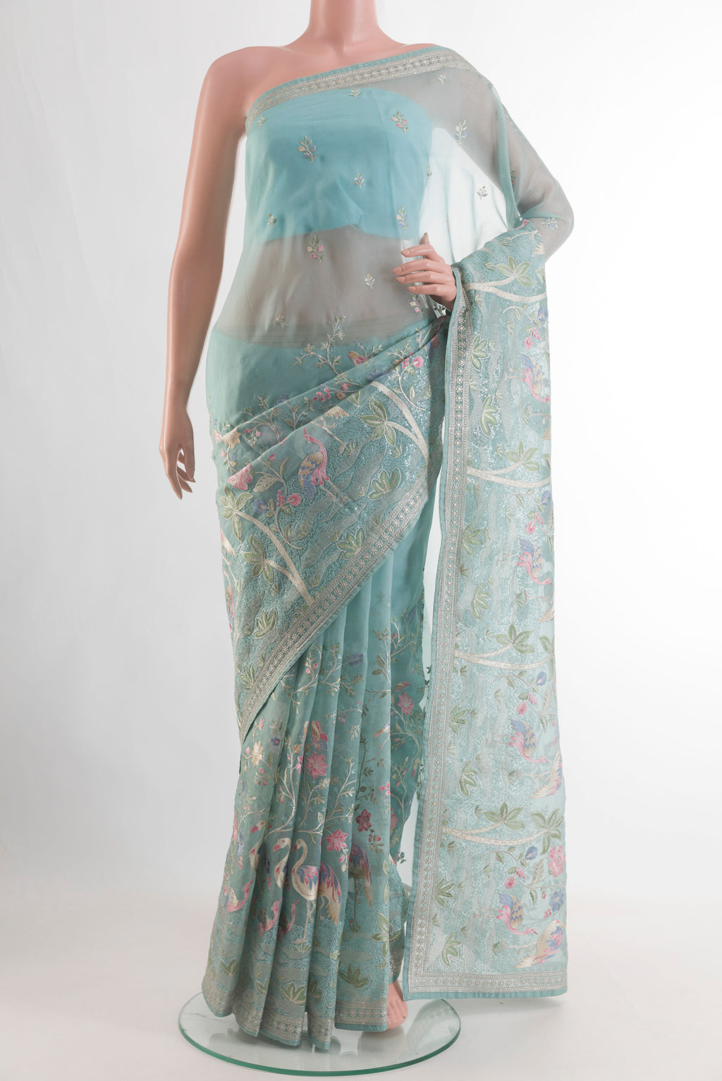 Pure Silk Light Blue Organza Saree with Embroidery on the body and Embroidery Border.  displayed on a mannequin