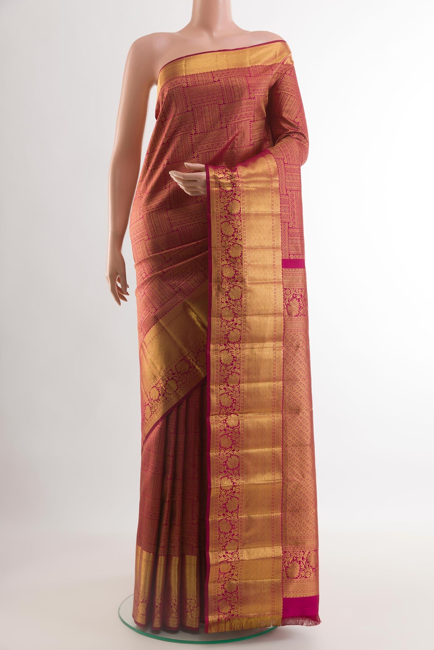 Magenta Kanchipuram Silk Saree with Zari Butta on the body and Zari Border.  displayed on a mannequin