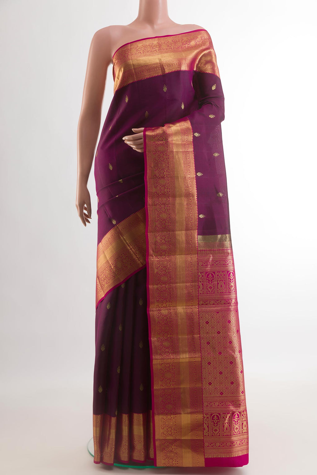 Purple Kanjivaram Silk Saree with Zari Butta on the body and Zari Border.  displayed on a mannequin