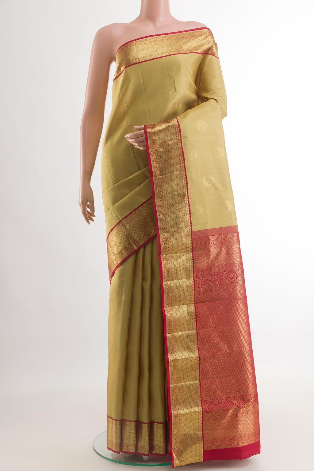Beige Kanchipuram Silk Saree with Zari Butta on the body and Zari Border.  displayed on a mannequin