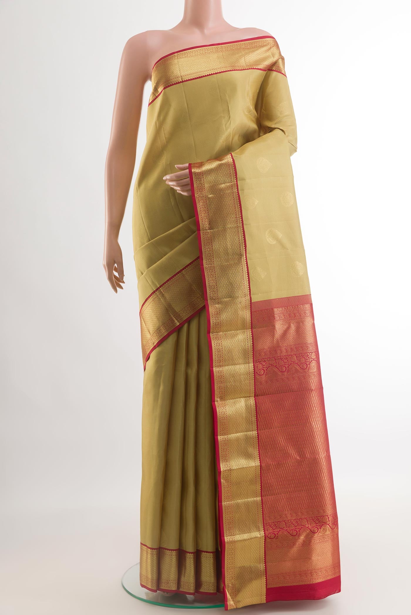 Beige Kanchipuram Silk Saree with Zari Butta on the body and Zari Border.  displayed on a mannequin