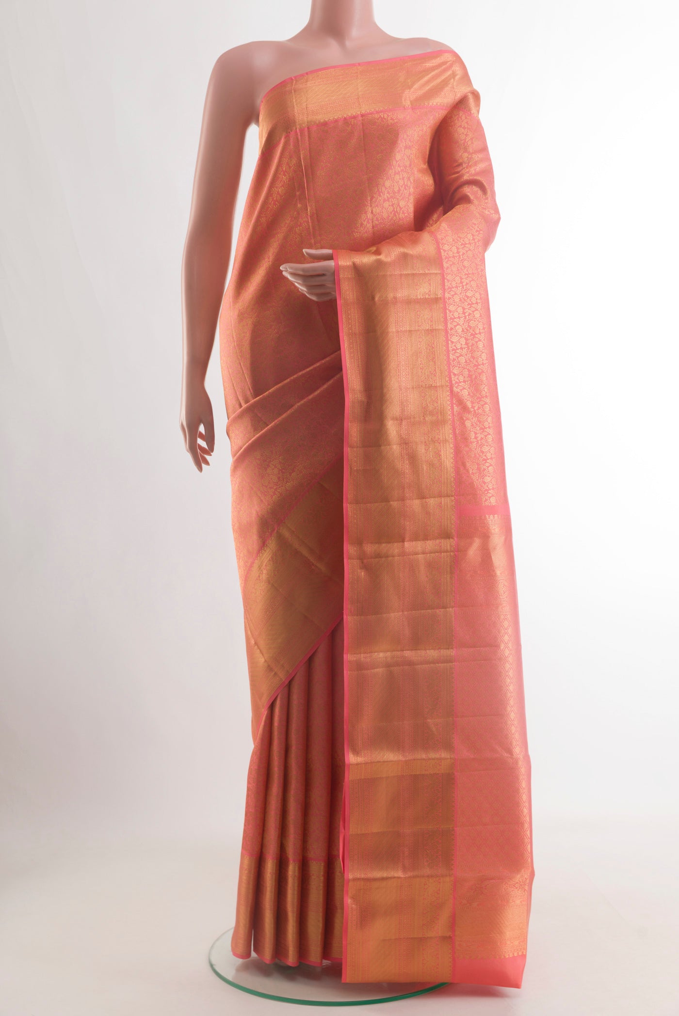 Coral Kanchipuram Silk Saree with Zari Brocade on the body and Zari Border.  displayed on a mannequin