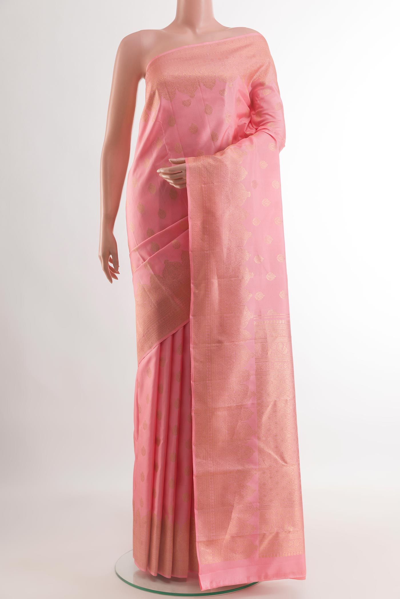 Rose pink Kanchipuram Silk Saree with Zari Butta on the body and Zari Border.  displayed on a mannequin