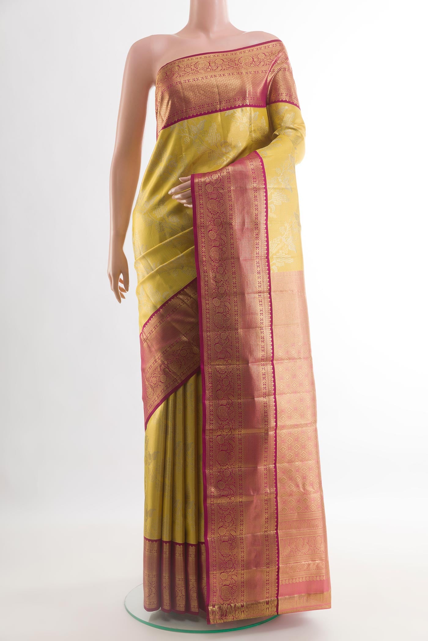 Gold Kanchipuram Tissue Silk Saree with Zari Brocade on the body and Zari Border.  displayed on a mannequin