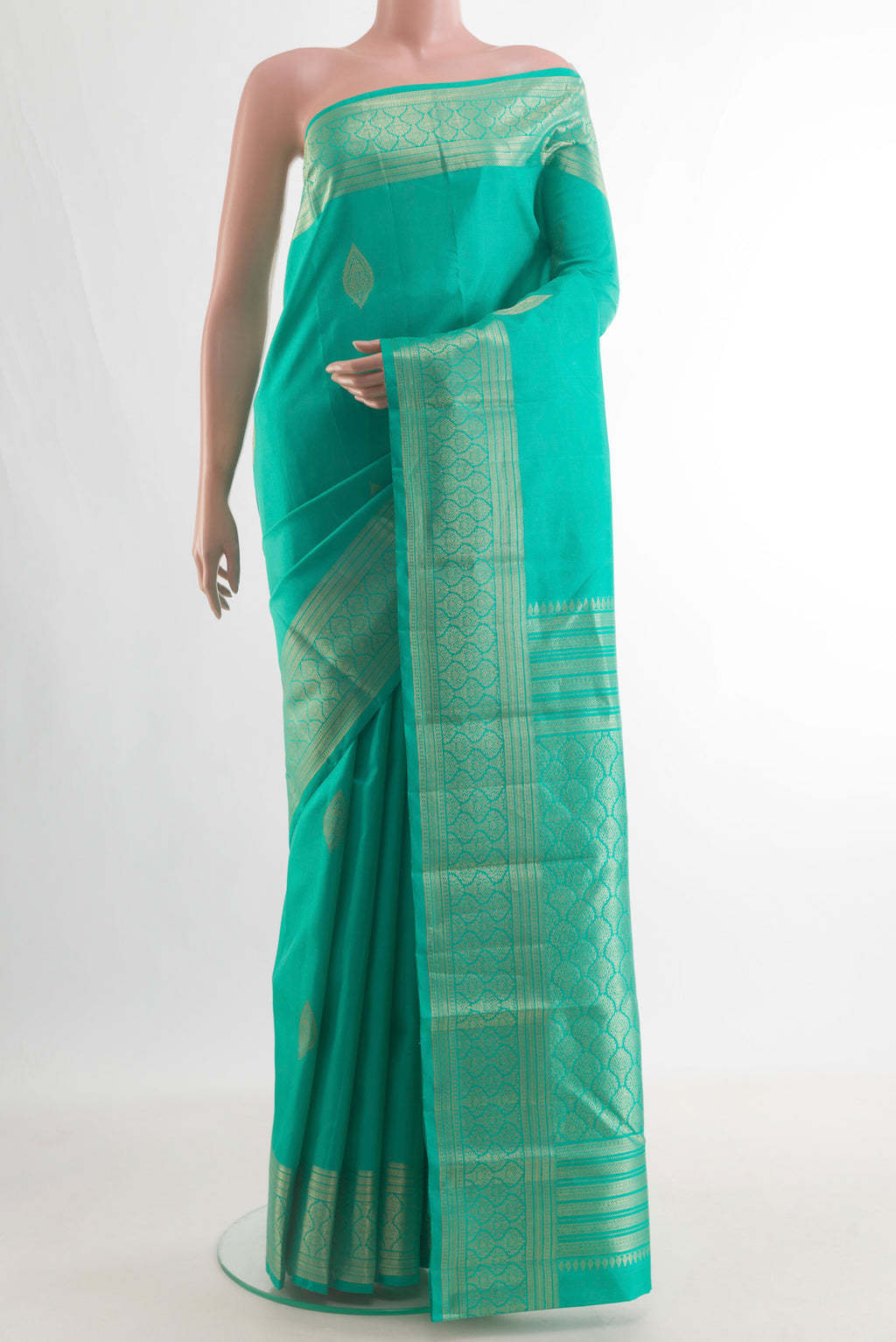 Pure Silk Sea Green Kanchipuram Saree with Zari Butta on the body and Zari Border.  displayed on a mannequin