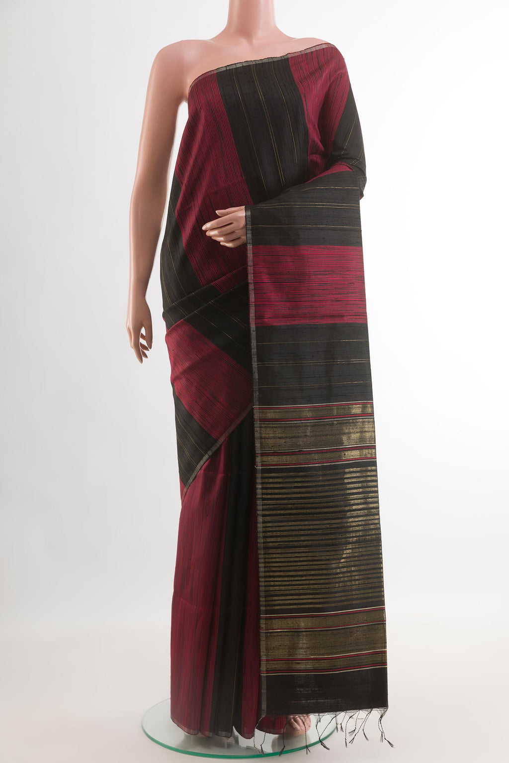 Black Tussar Saree with Stripes on the body and Zari Border.  displayed on a mannequin