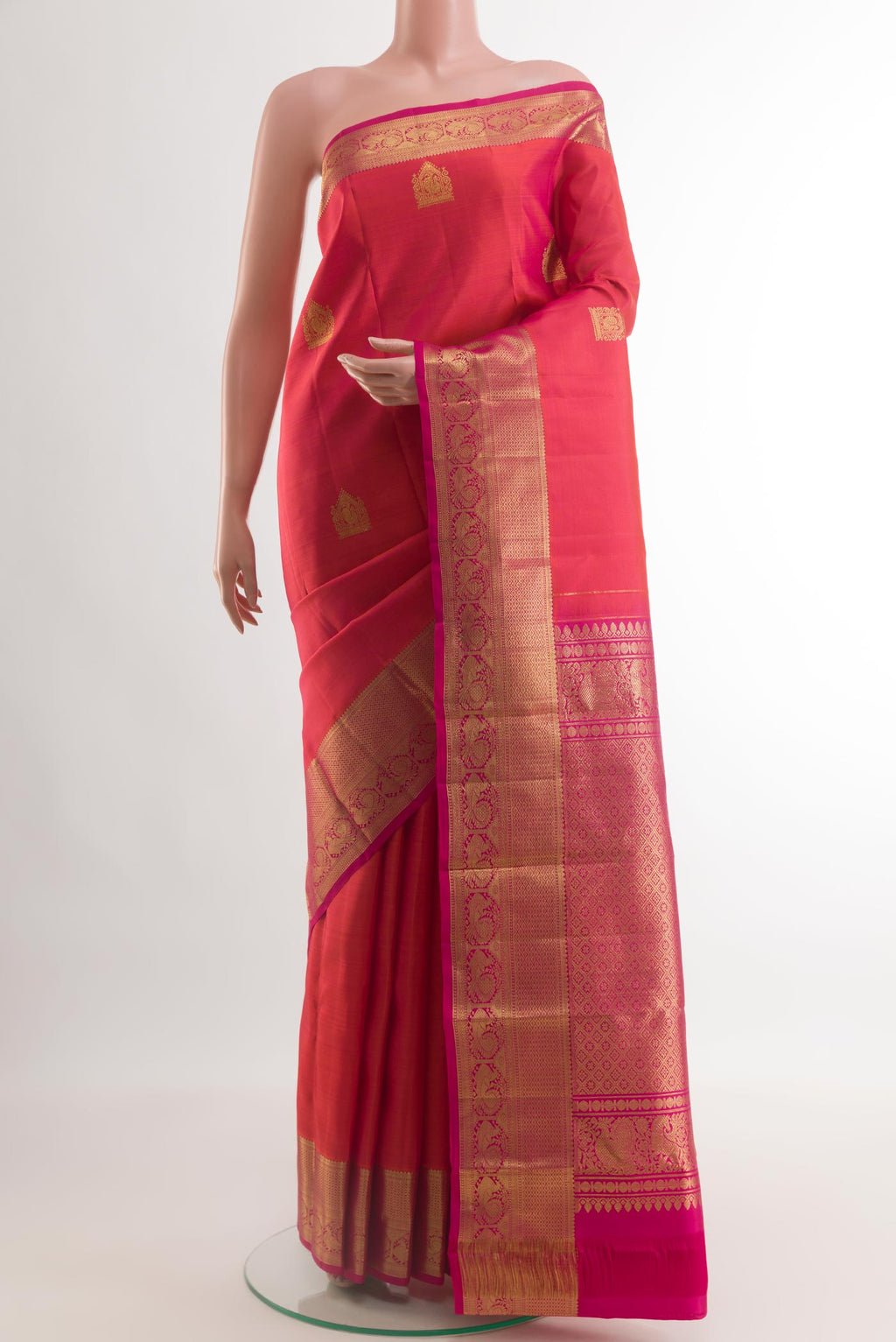 Coral Dual Tone Kanchipuram Silk Saree with Zari Butta on the body and Zari Border.  displayed on a mannequin