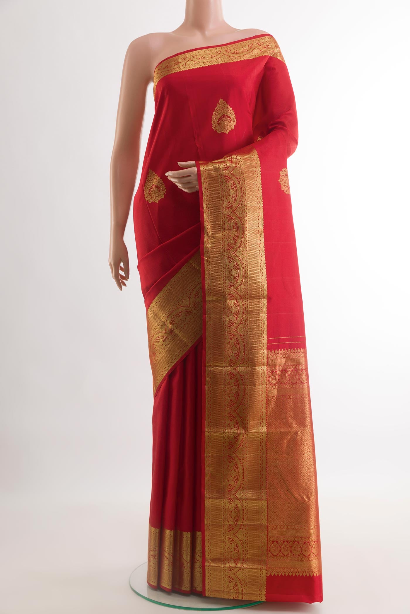 Red Kanchipuram Silk Saree with Zari Butta on the body and Zari Border.  displayed on a mannequin