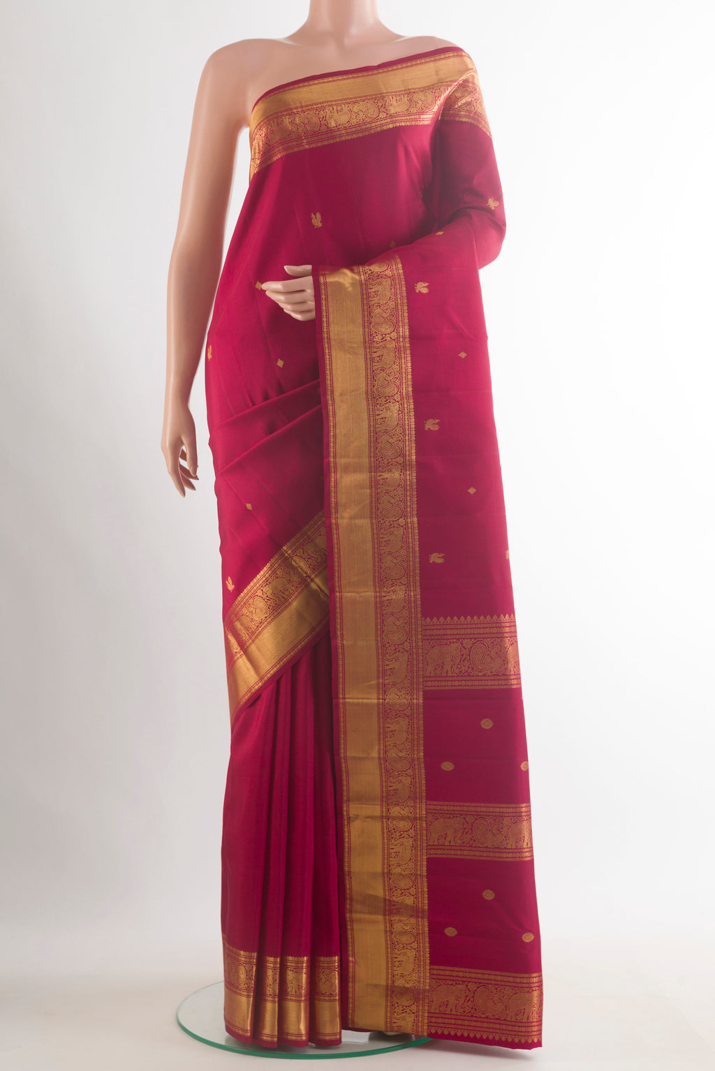 Pure Silk Maroon Kanchipuram Saree with Zari Butta on the body and Zari Border.  displayed on a mannequin