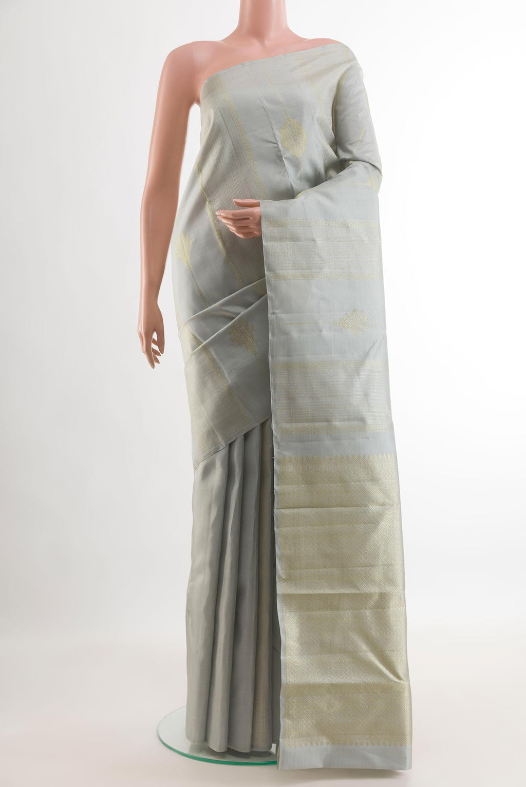 Grey Kanjivaram Silk Saree with Zari Butta on the body and Zari Border.  displayed on a mannequin