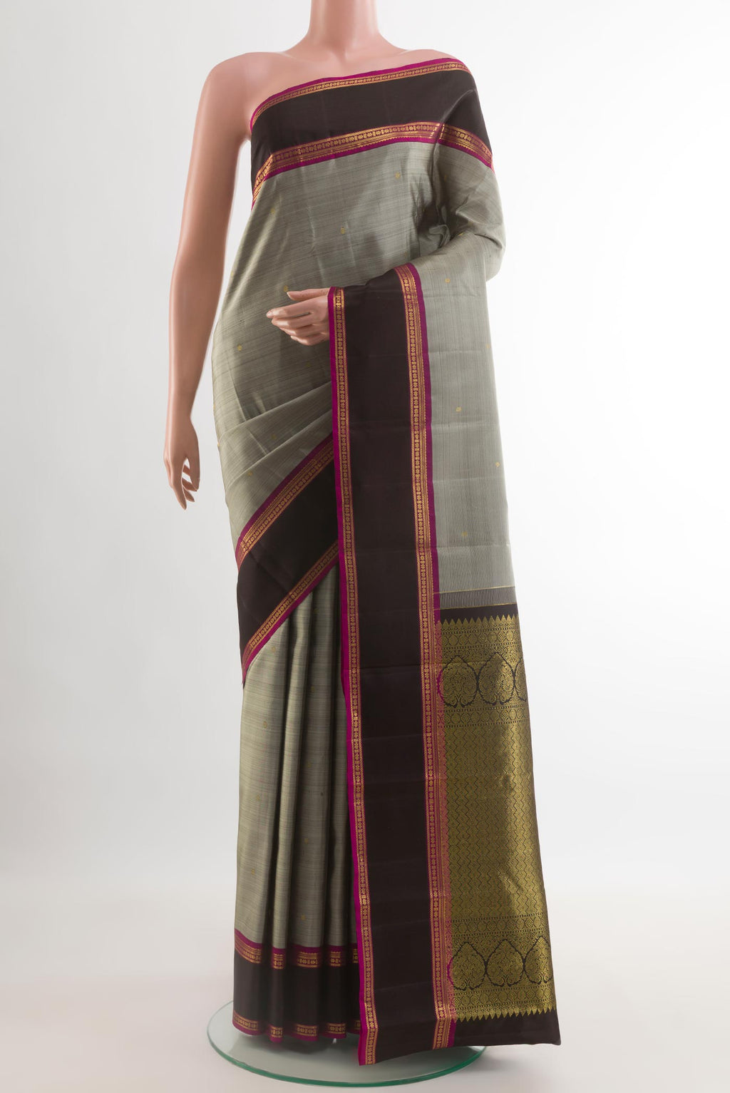 Grey Kanjivaram Silk Saree with Zari Butta on the body and Zari Border.  displayed on a mannequin