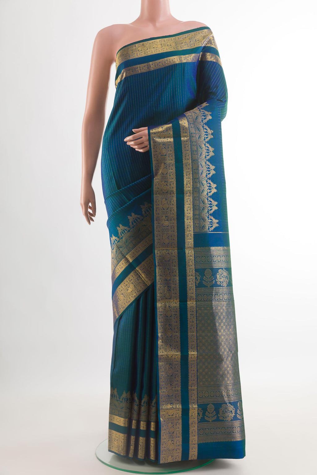 Peacock Blue Kanjivaram Silk Saree with Stripes on the body and Zari Border.  displayed on a mannequin