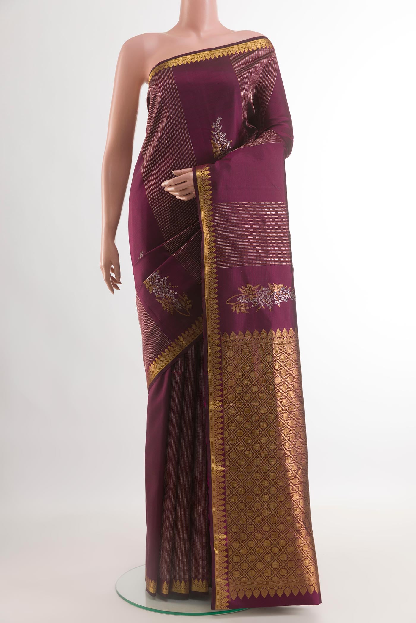 Purple Kanjivaram Silk Saree with Zari Butta on the body and Zari Border.  displayed on a mannequin