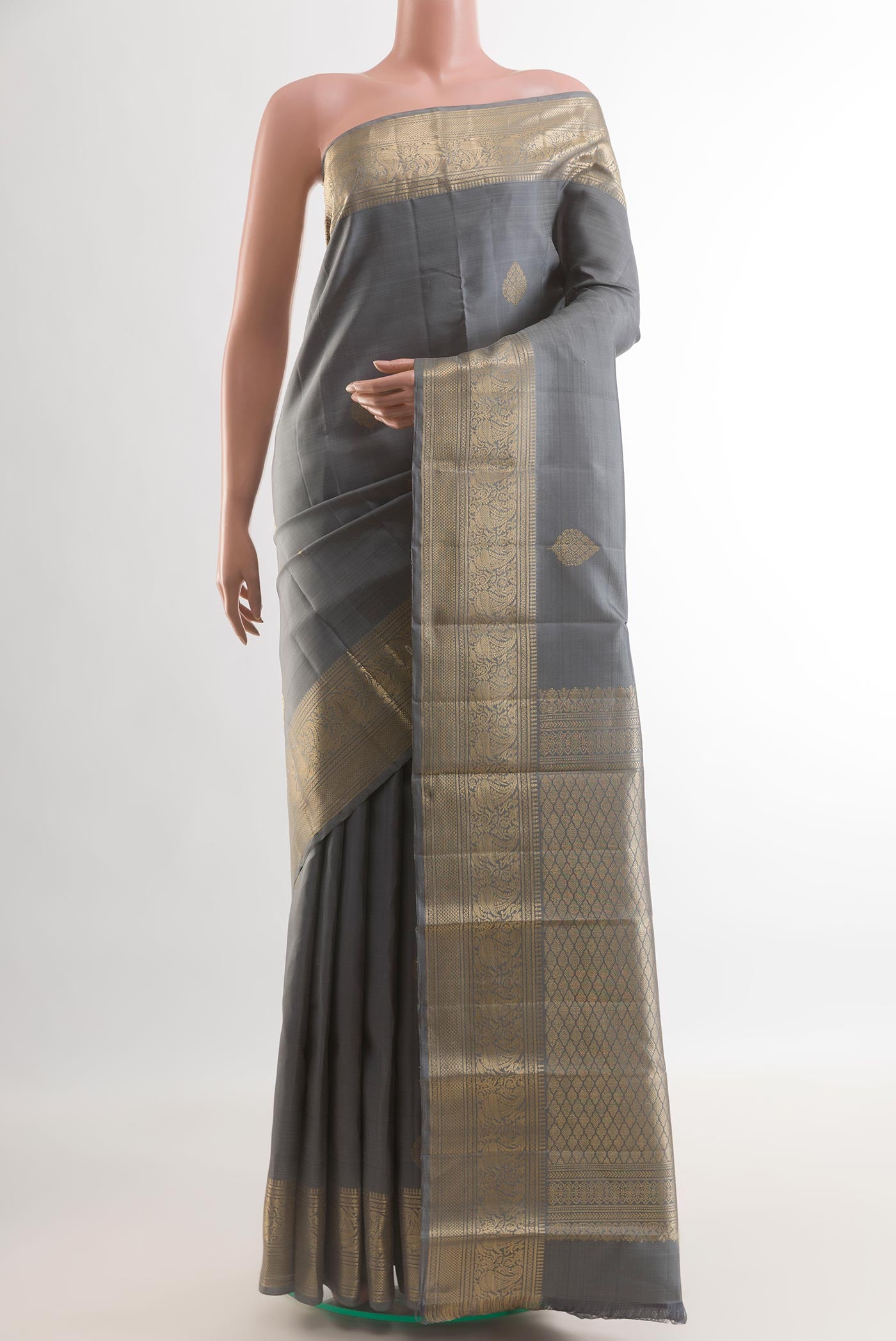 Grey Kanchipuram Silk Saree with Zari Butta on the body and Zari Border.  displayed on a mannequin