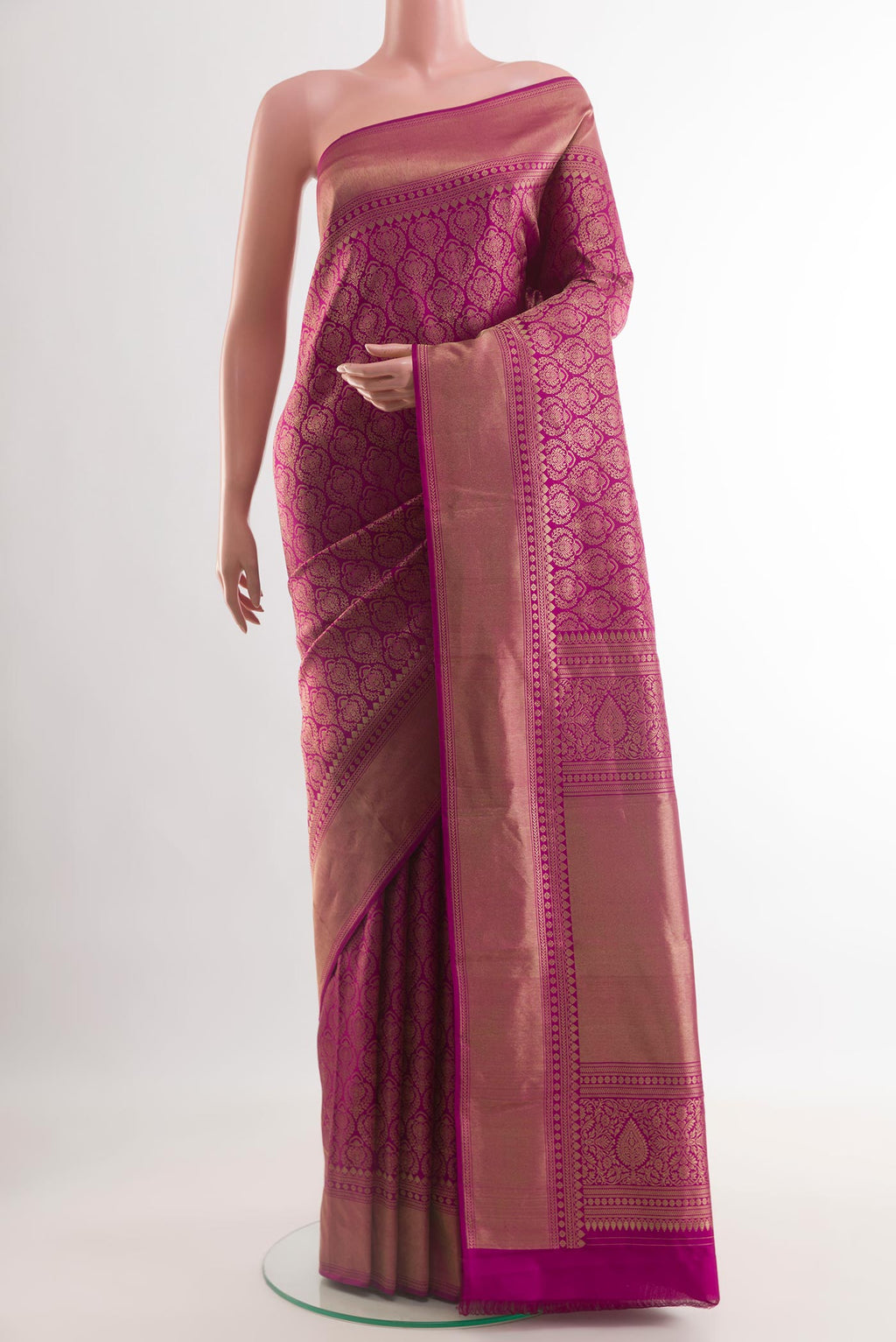 Magenta Kanchipuram Silk Saree with Zari Brocade on the body and Zari Border.  displayed on a mannequin