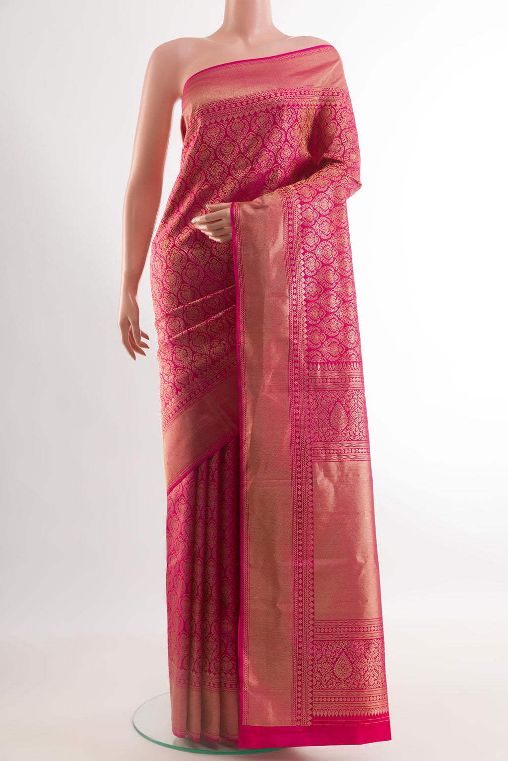 Rani Pink Kanchipuram Silk Saree with Zari Brocade on the body and Zari Border.  displayed on a mannequin