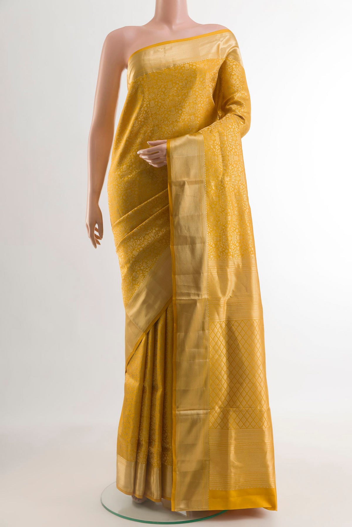 Mustard Soft Silk Saree with Zari Brocade on the body and Zari Border.  displayed on a mannequin