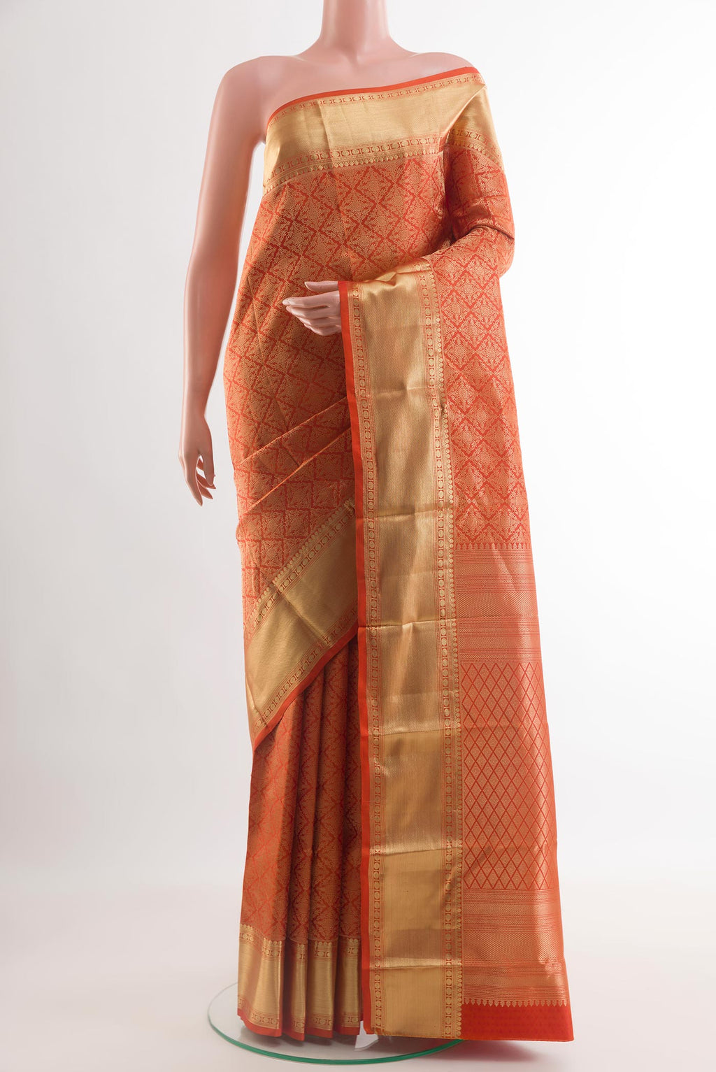 Orange Kanchipuram Silk Saree with Zari Brocade on the body and Zari Border.  displayed on a mannequin