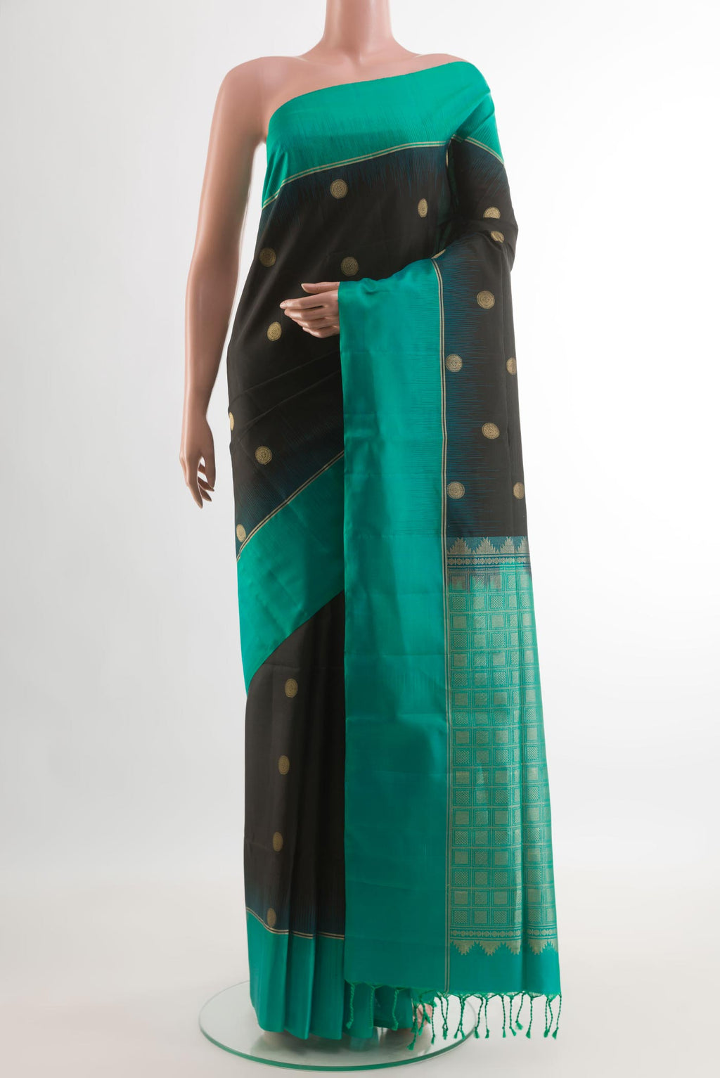 Black Soft Silk Saree with Zari Butta on the body and Zari Border.  displayed on a mannequin