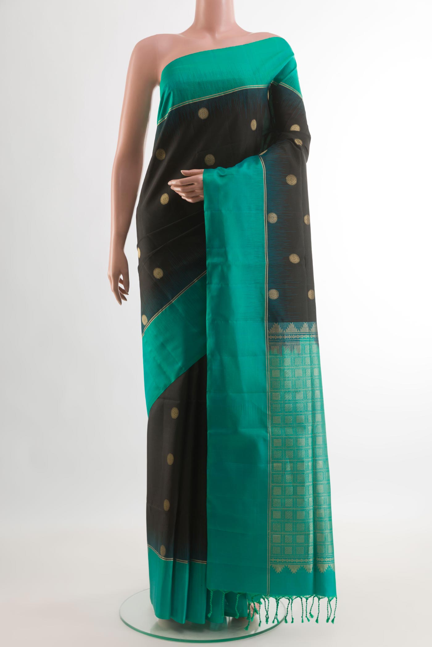 Black Soft Silk Saree with Zari Butta on the body and Zari Border.  displayed on a mannequin