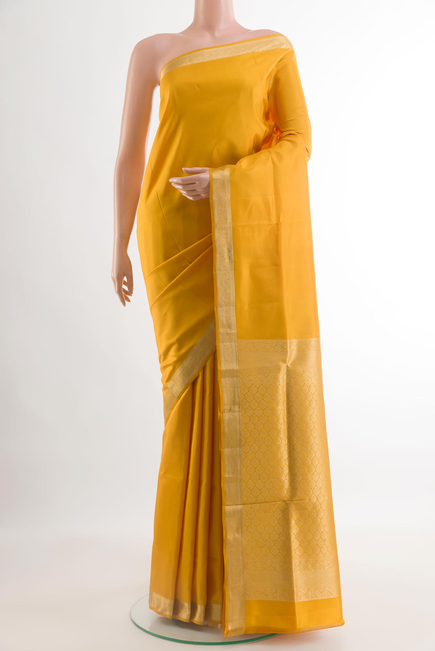 Yellow Soft Silk Saree with Plain Body and Zari Border.  displayed on a mannequin