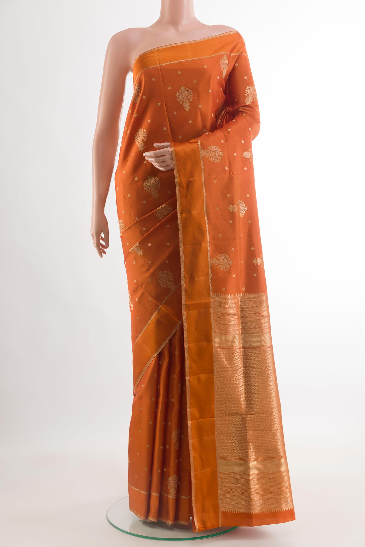 Orange Soft Silk Saree with Zari Butta on the body and Zari Border.  displayed on a mannequin