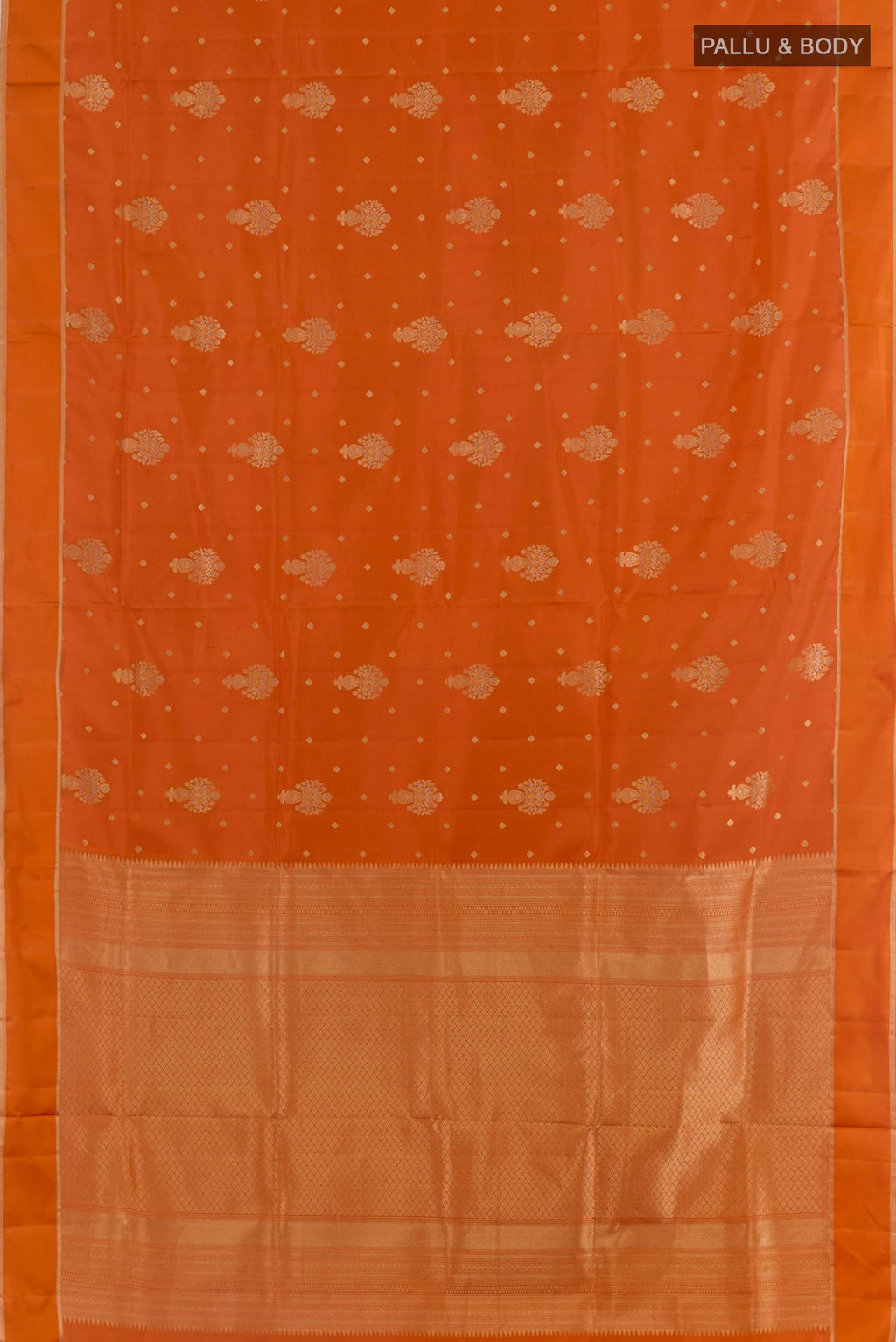 Flat view of Orange Soft Silk Saree with Zari Butta on the body and Zari Border. 