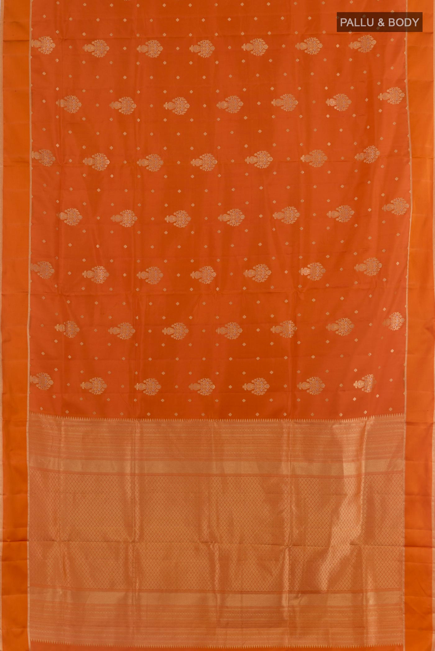 Flat view of Orange Soft Silk Saree with Zari Butta on the body and Zari Border. 