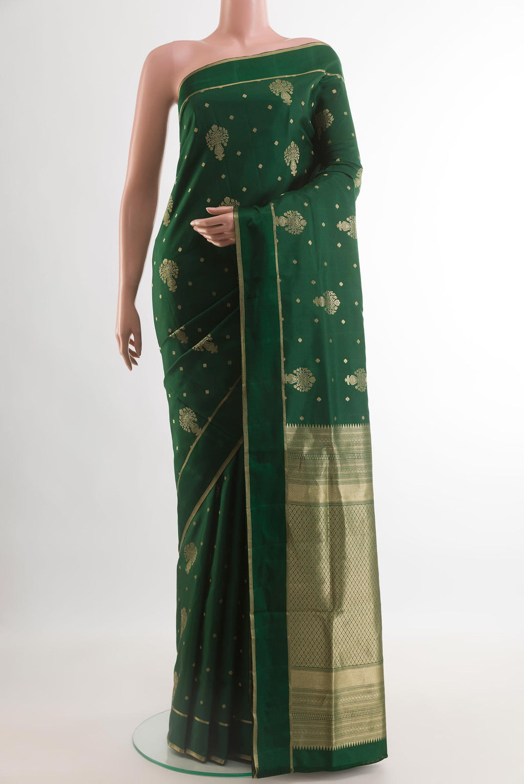 Bottle Green Soft Silk Saree with Zari Butta on the body and Zari Border.  displayed on a mannequin