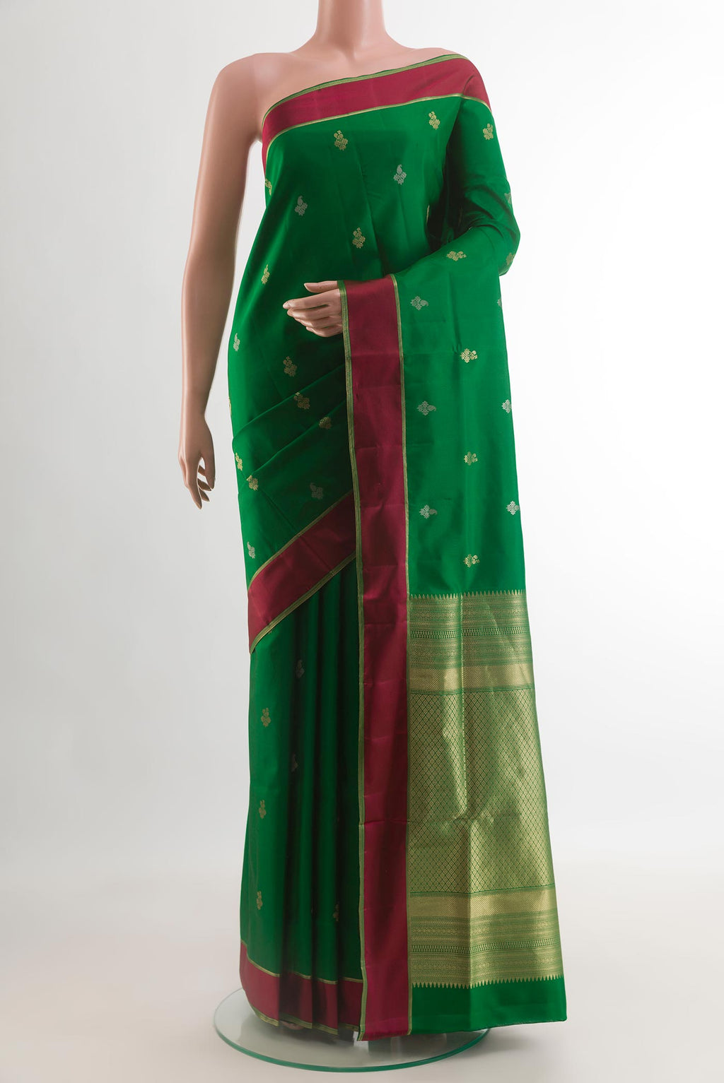 Green Soft Silk Saree with Zari Butta on the body and Thread Border.  displayed on a mannequin