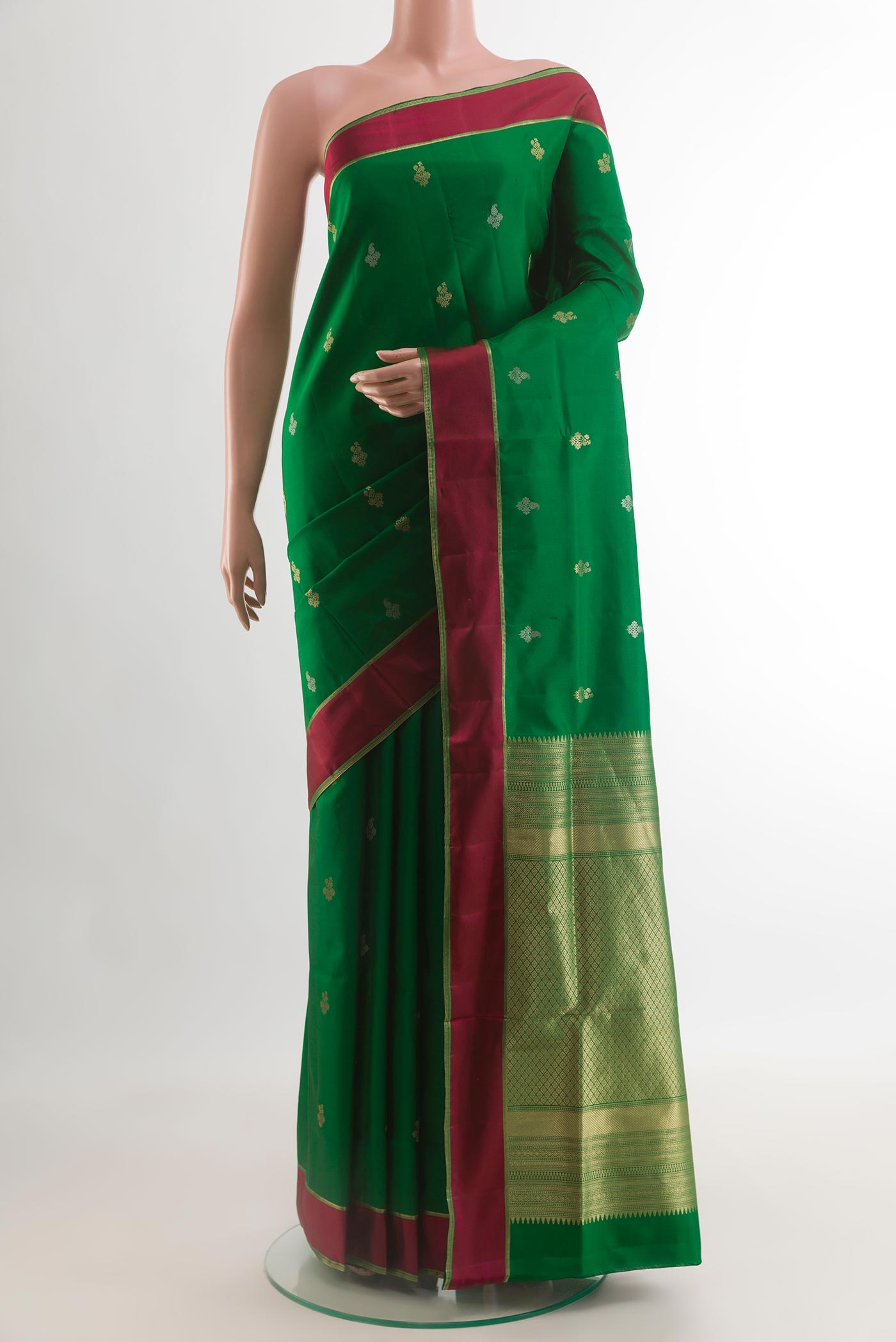 Green Soft Silk Saree with Zari Butta on the body and Thread Border.  displayed on a mannequin