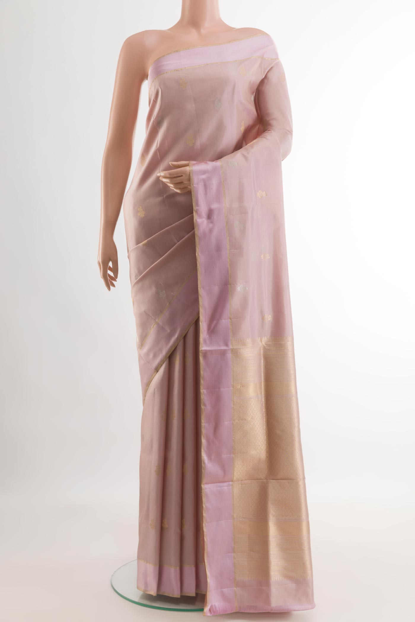 Rose Gold Soft Silk Saree with Zari Butta on the body and Zari Border.  displayed on a mannequin