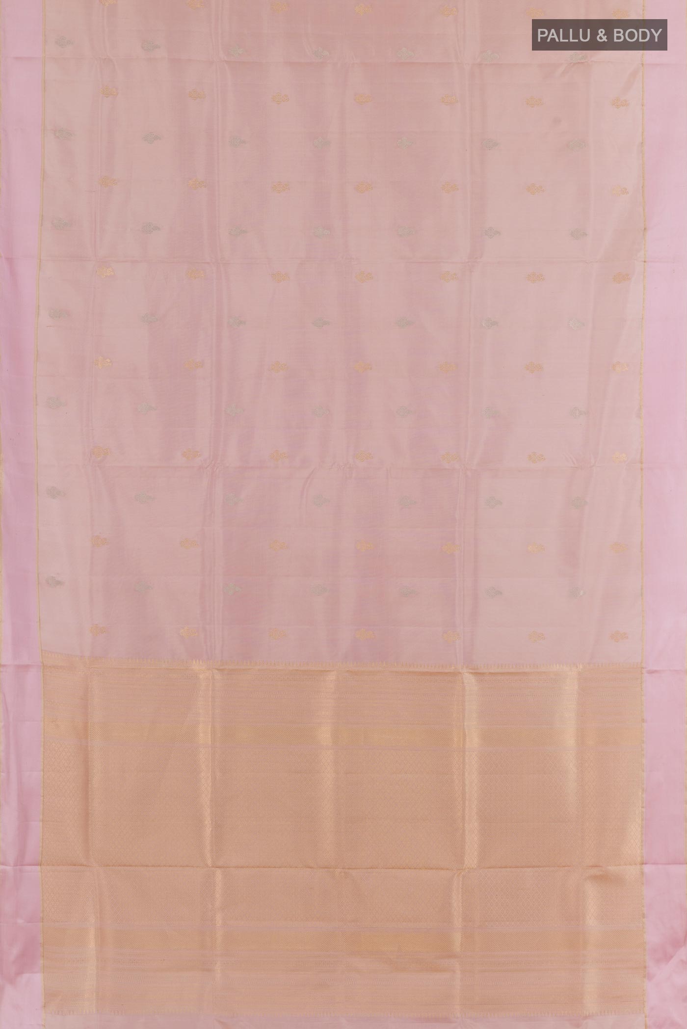 Flat view of Rose Gold Soft Silk Saree with Zari Butta on the body and Zari Border. 