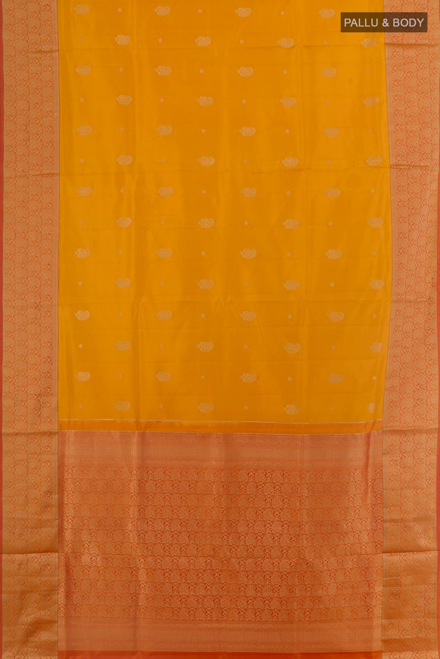 Flat view of Mustard Soft Silk Saree with Zari Butta on the body and Zari Border. 