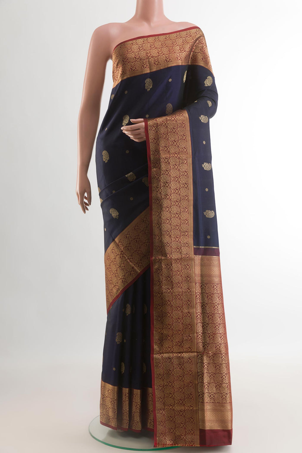 Navy Blue Soft Silk Saree with Zari Butta on the body and Zari Border.  displayed on a mannequin