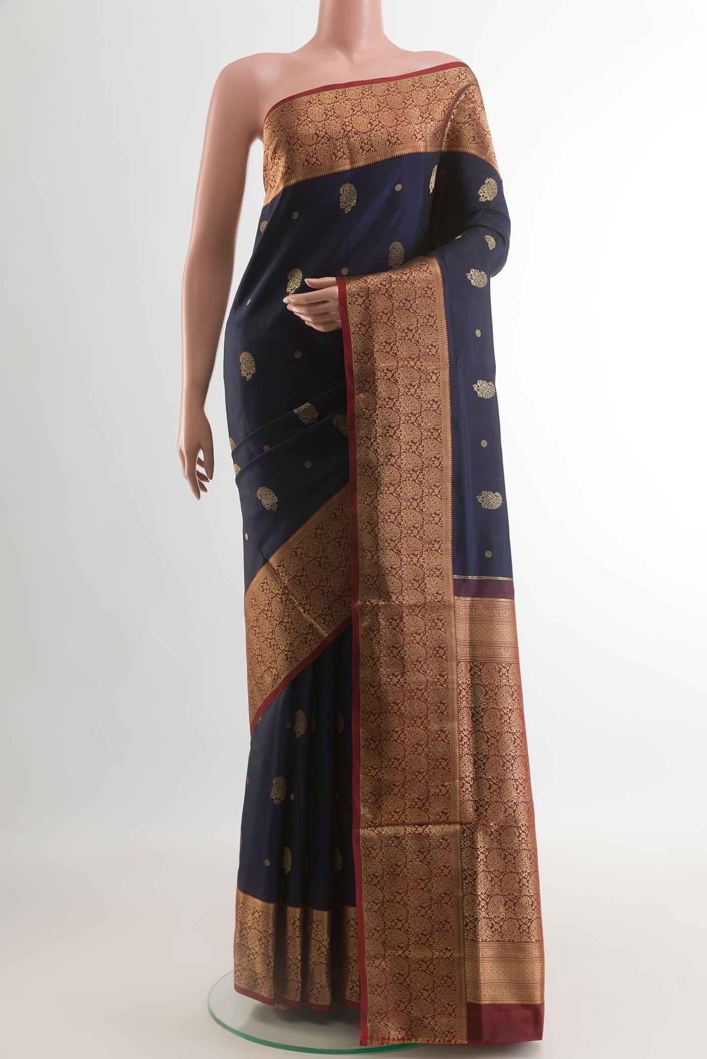Navy Blue Soft Silk Saree with Zari Butta on the body and Zari Border.  displayed on a mannequin